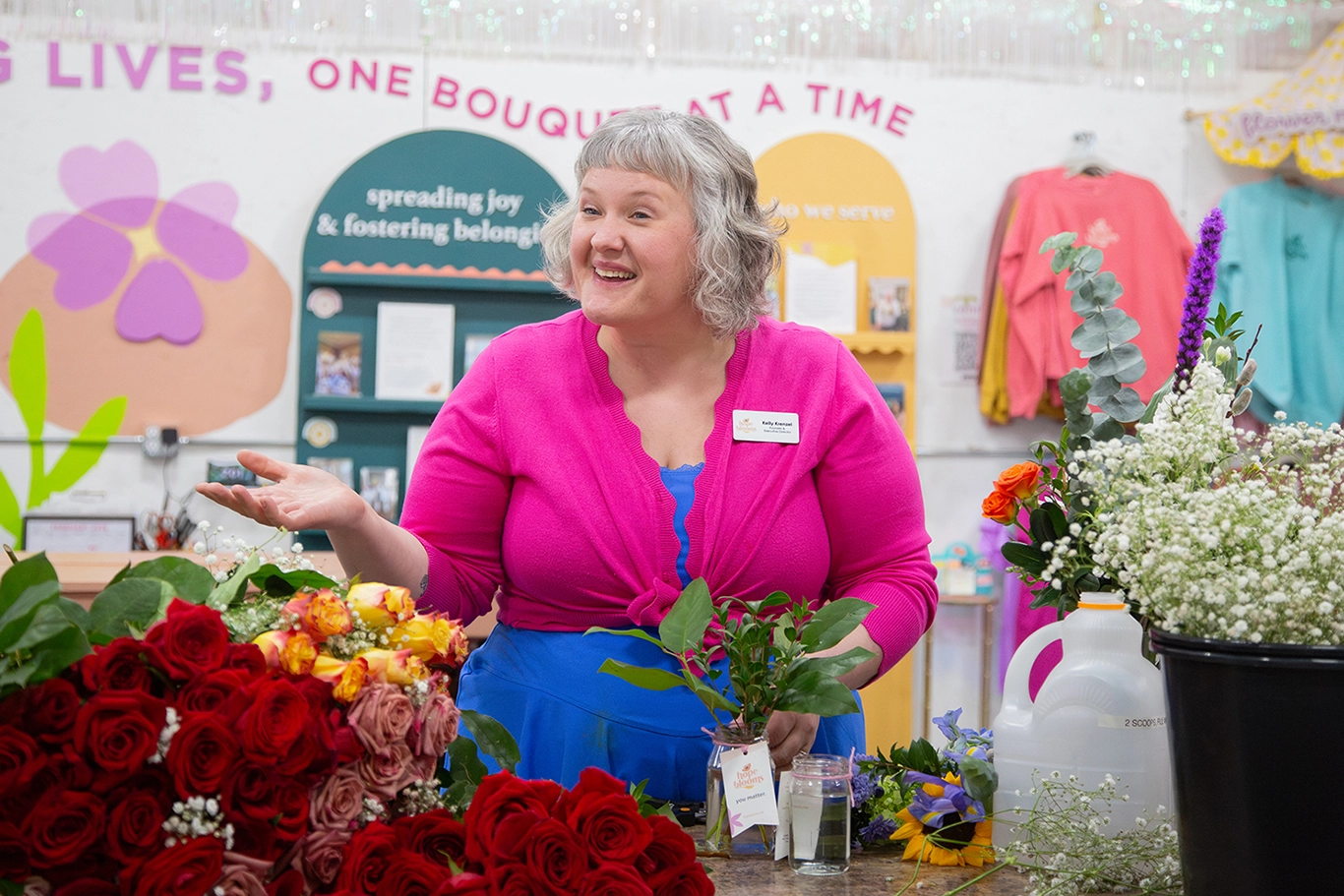 Kelly preparing a bouquet of flowers in Hope Blooms' space