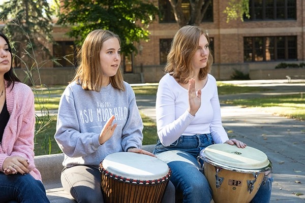 Students playing hand drums