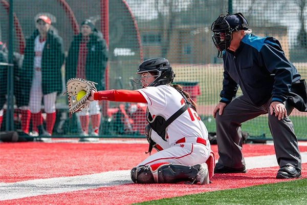 Dragons fast-pitch softball catcher catching softball