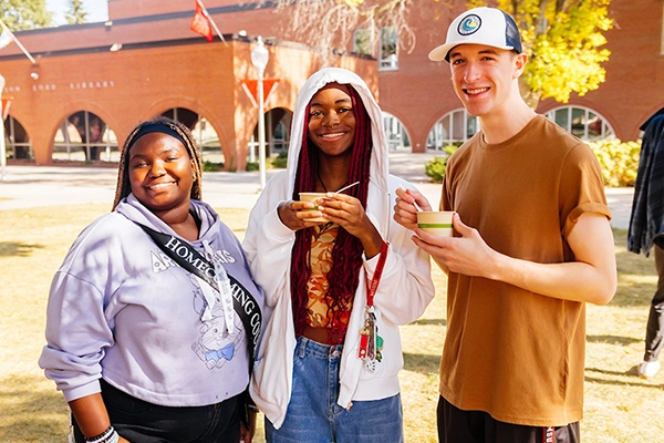 Three students participating in the chili feed
