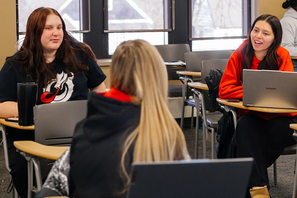Three students engaging in classroom conversation