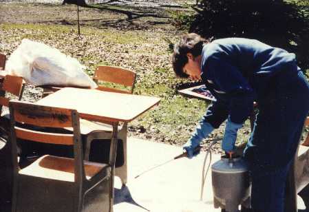 1997 Flood - A student decontaminates desks and other classroom furniture.